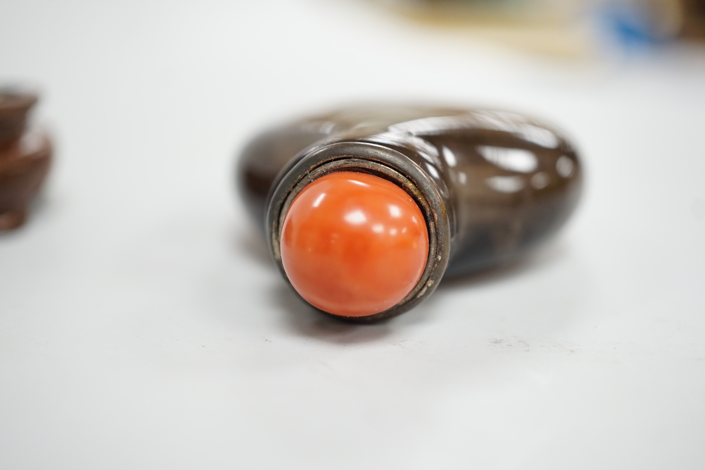 A Chinese smoky quartz snuff bottle, 18th/19th century, well hollowed, 4.7cm, coral stopper